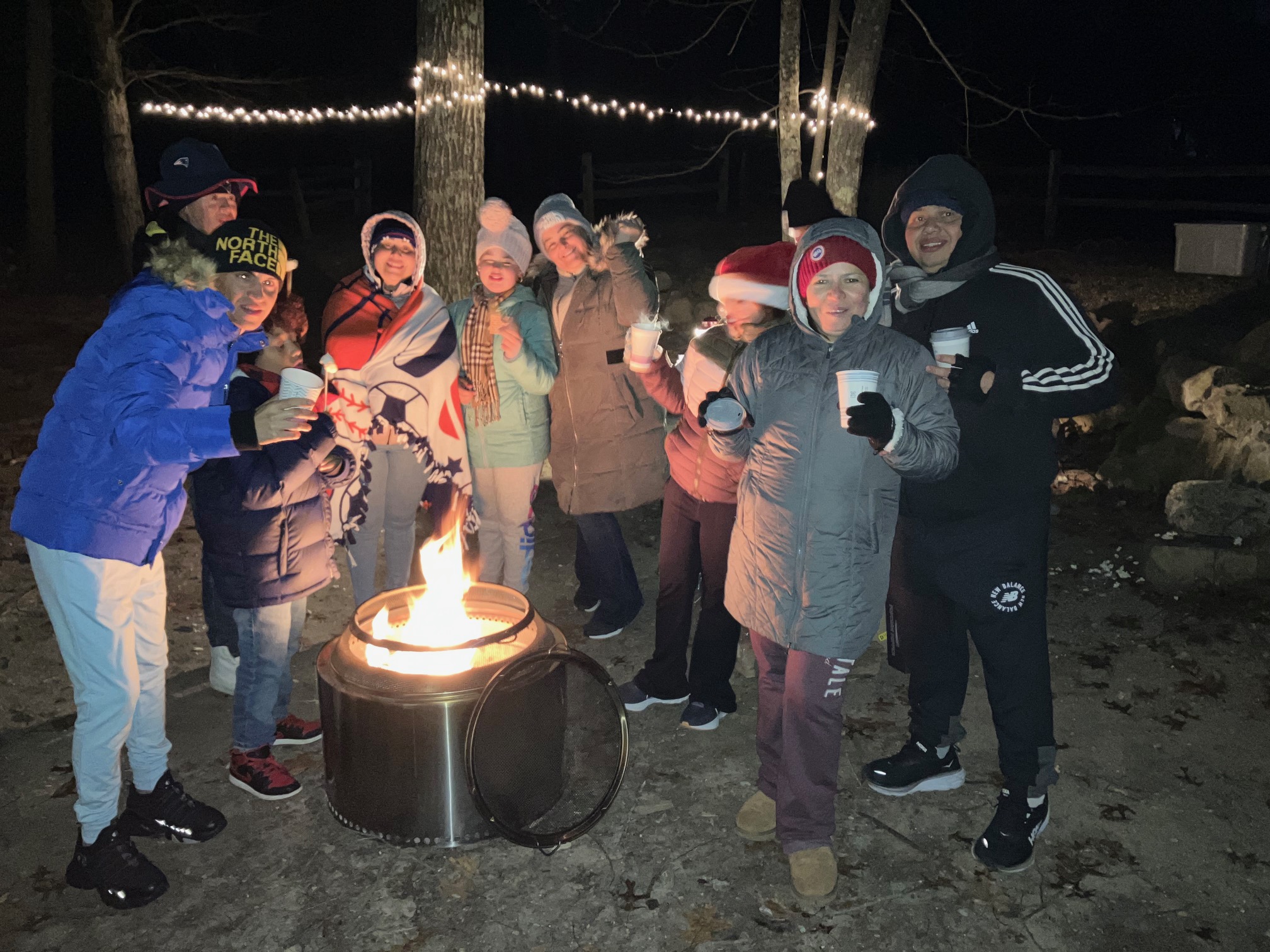 Photo of people around an outdoor bonfire.